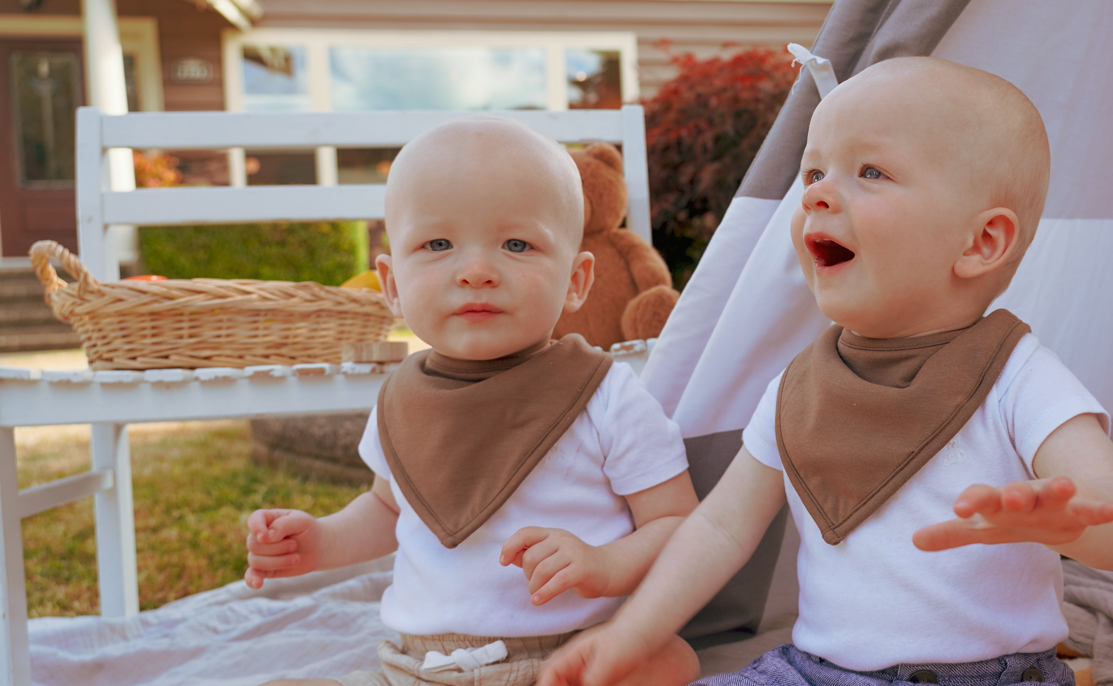 Two babies wearing magnetic bibs